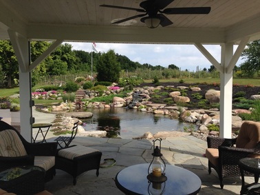 Landscape Design, Stone Patio & Pond Renovation/Installation Are Great Outdoor living Area Ideas In Rochester (NY) - Contact Acorn Ponds & Waterfalls To Get Started on Your Paradise. Image