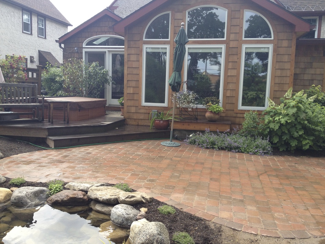 Outdoor room with hot tub & landscape design installed with fish pond, patio renovation, and plantings in Greece Monroe County NY By Acorn Of Rochester New York (NY)