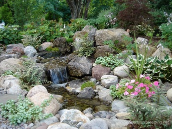 Pondless waterfall water feature, courtyard, landscape design & patio installed in Rochester New York (NY) By Acorn Ponds & Waterfalls. 