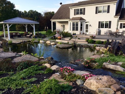 Large recreational fish pond installed by Acorn Ponds & Waterfalls in Rochester NY