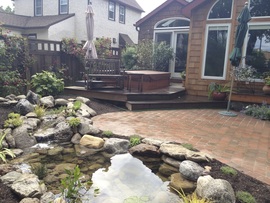 Enjoy the water feature lifestyle with a low maintenance koi fish pond in Rochester New York (NY) by Acorn Ponds & Waterfalls
