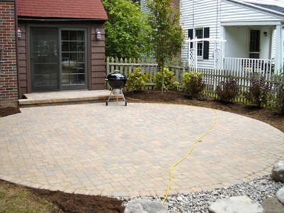 Circular shaped patio design & installation in Rochester New York (NY) by Acorn Ponds & Waterfalls.
