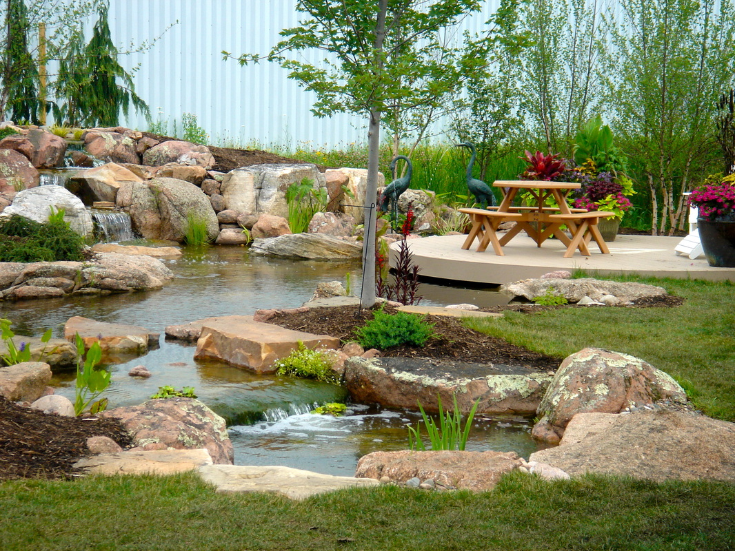 Destination and fish feeding boulders in ponds used by Acorn Ponds & Waterfalls 